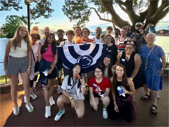 group of people standing with flag