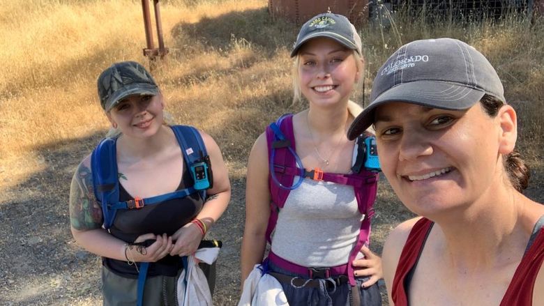 three women posing for selfie wearing backpacks