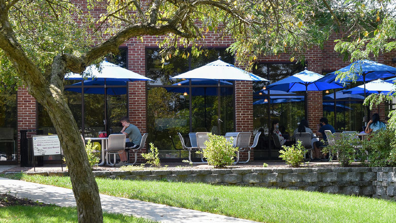 Brick outdoor patio with tables and umbrellas