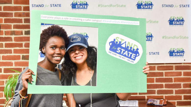 Students pose with Stand for State materials.