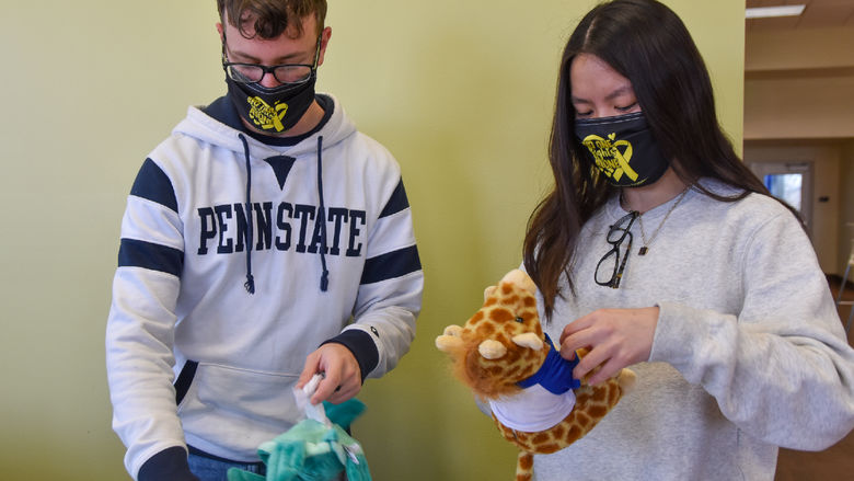 Male and femal students stuff plush animals for children