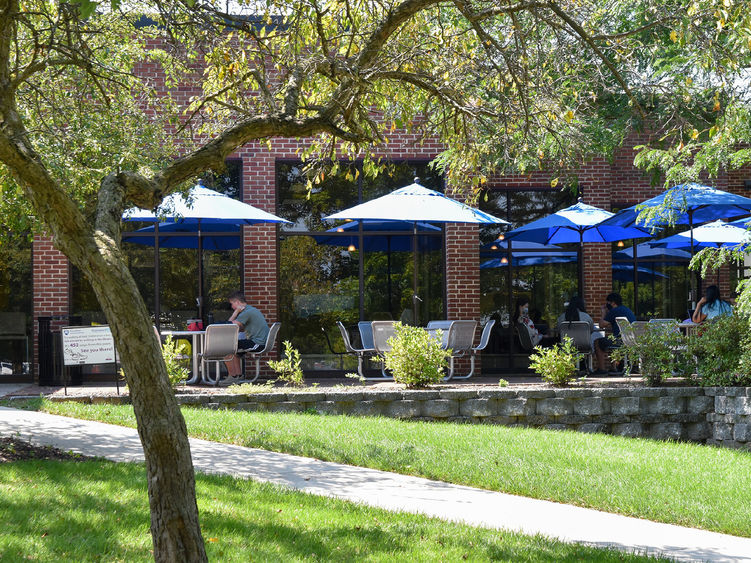 Brick outdoor patio with tables and umbrellas