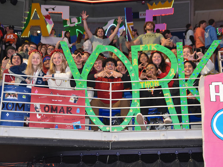 Crowd of male and female students holind large letters to spell the word YORK